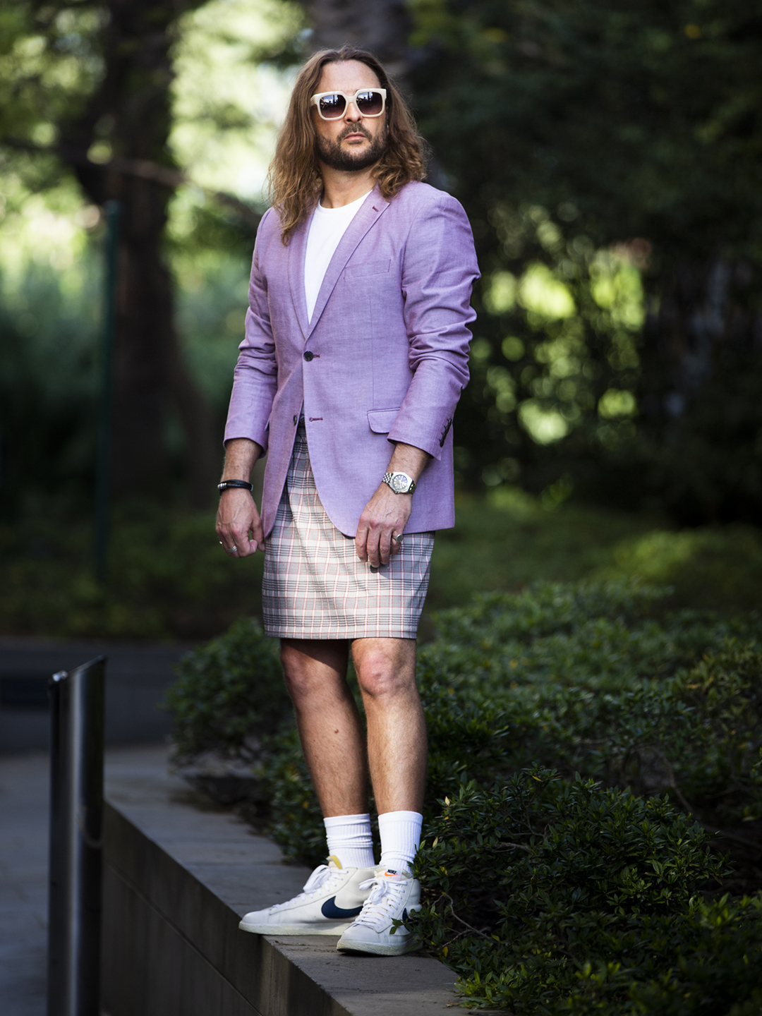 Brad in a lilac blazer, plaid skirt, white socks and trainers