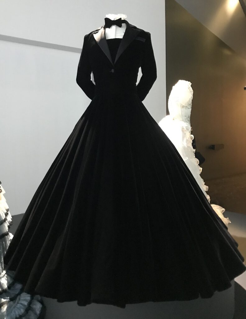 Billy Porter’s black velvet tuxedo gown by Christian Siriano displayed in a museum