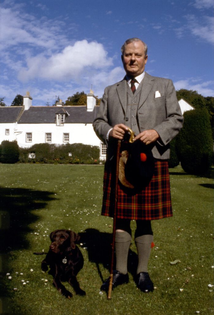 James Carnegie, 3rd Duke of Fife, wearing a red tartan kilt in a garden