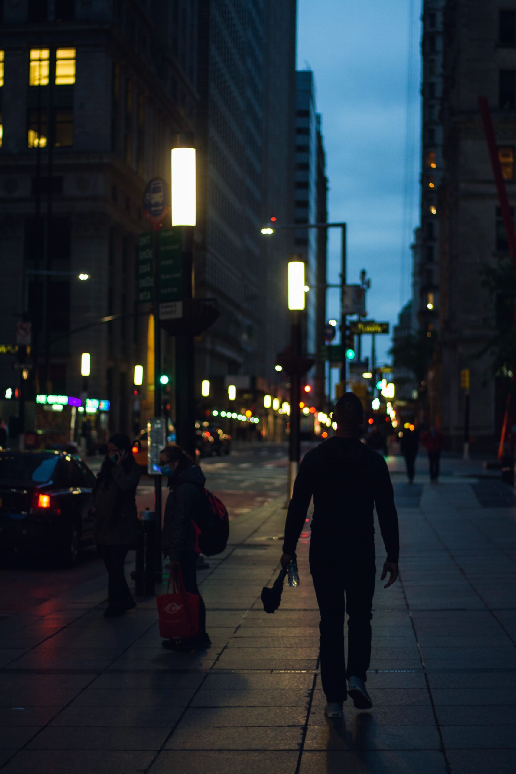 Man walking alone along a city street at night