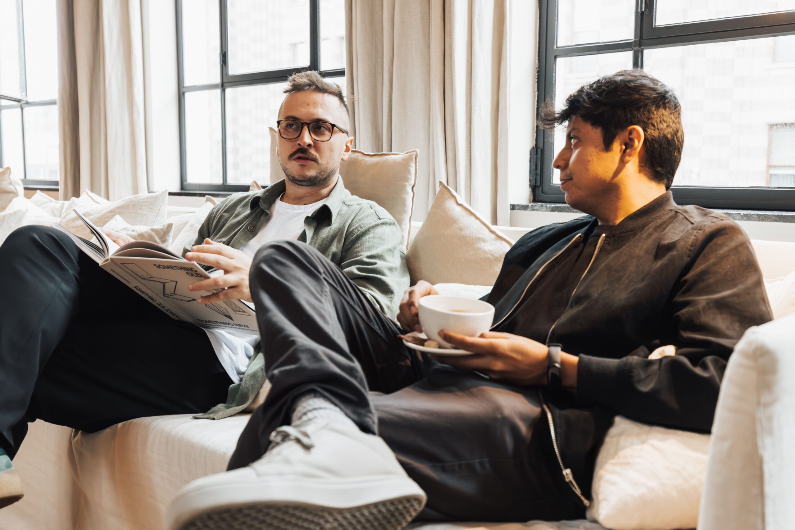 Two men talking together over coffee